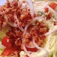 Iceberg Wedge · A crisp wedge of iceberg lettuce, crumbled blue cheese, red bacon and diced tomatoes. Served...