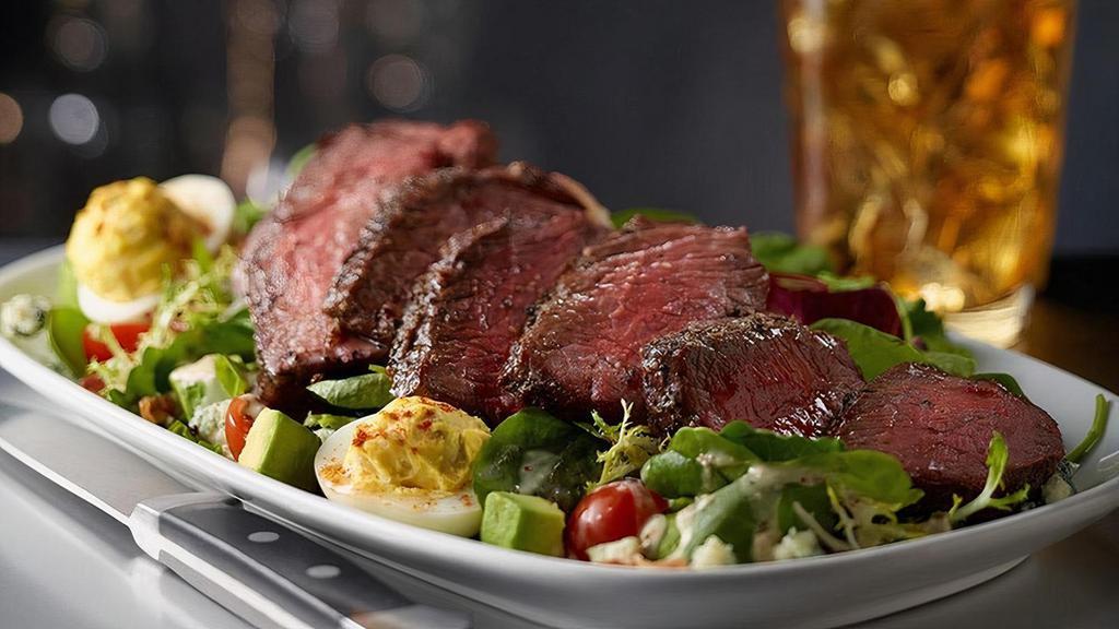 Steakhouse Salad With Steak · Prime Strip Steak, Mixed Greens, Avocado, Applewood Smoked Bacon, Hard-Boiled Egg, Parmesan, Blue Cheese, Cherry Tomatoes, Suggested Dressing - Sweet Basil Vinaigrette