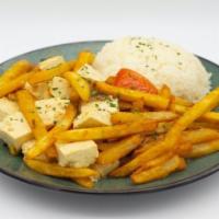 Vegan Tofu Lomo Saltado · tofu, thick fries, tomatoes, charred sweet red onions, white wine soy, served with steamed w...