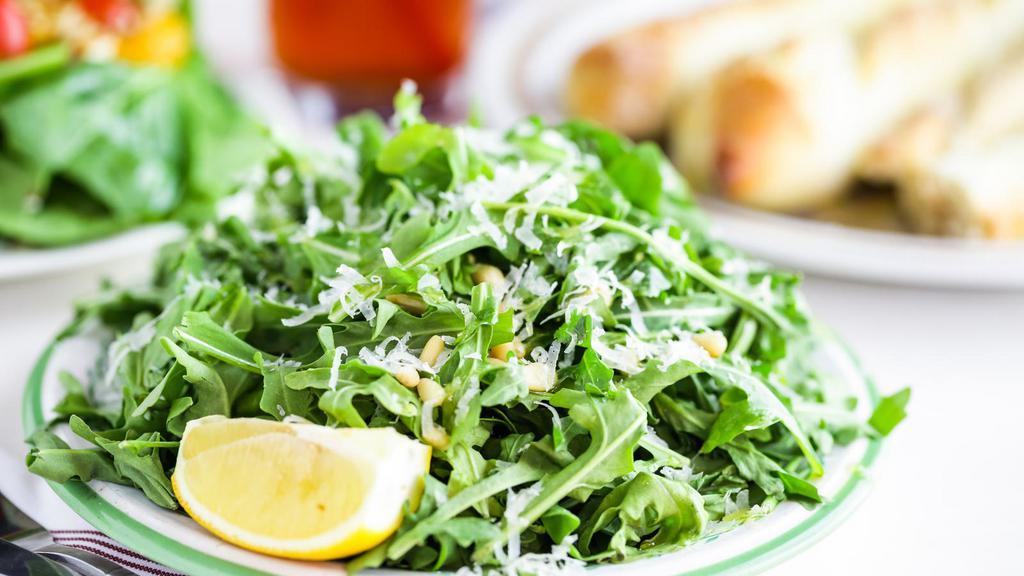 Arugula Salad · Fresh arugula, tossed with shaved Parmesan cheese, pine nuts and avocado. Paired excellently with the citrus vinaigrette dressing.