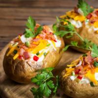 Baked Potatoes (Papas Al Horno) · Baked Potato with butter, sour cream cheese mix and the meat.