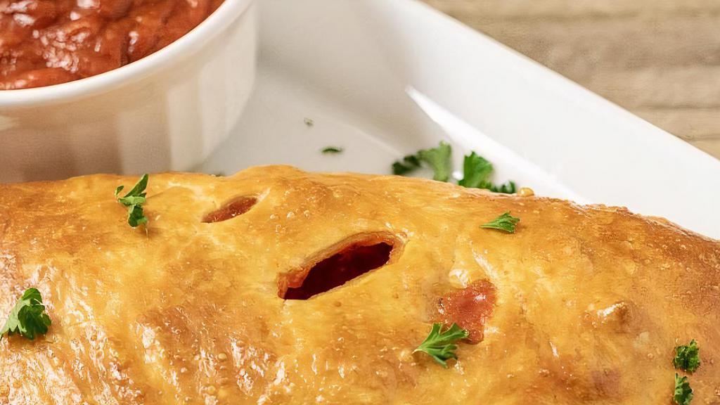 Pepperoni Calzone · mozzarella cheese and pepperoni, with a side of marinara.