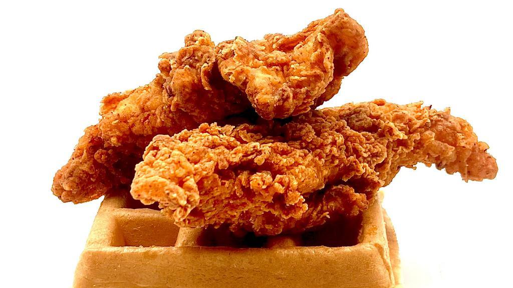 Fried Chicken & Waffles · Two large fried chicken breast tenders served with a buttermilk waffle and syrup.