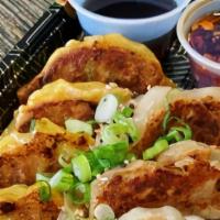 Chicken Gyoza (Potstickers) · 9 pc chicken gyozas, dumpling sauce, chili sauce, soy sauce.