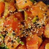 Spicy Tuna Poke · Spicy tuna, spring mix, seaweed salad, scallions, sesame seeds, chili oil.