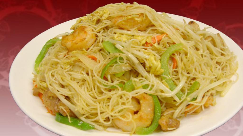 Singapore Noodles · Stir-fried curry flavored rice noodles mixed with egg, chicken, shrimp, bell peppers, yellow onions, and carrots.