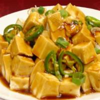 Szechuan Style Tofu · Stir-fried tofu with a spicy and savory sauce topped with jalapeños.
