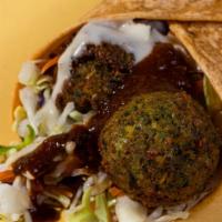 Falafel Wrap · The Falafel Wrap comes with, hummus, harissa sauce, cabbage mix, falafel and lemon tahini wr...
