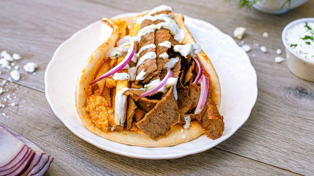 Cali Pita · hand-carved gyros or grilled chicken, fire feta, onions, tzatziki and french fries on warm pita. Served in a unleavened flatbread.