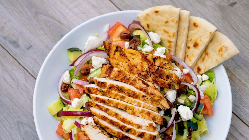 Greek Salad · Mixed greens tossed with Greek dressing, tomatoes, cucumbers, feta, kalamata olives, onions, and grilled chicken.