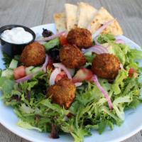 Falafel Salad · Vegan. Spring mixed greens tossed with lemon tahini dressing, topped with chickpea falafel, ...