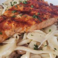 Salmon Piccata · Mesquite grilled salmon with lemon butter, mushrooms, and capers. Served over linguini.