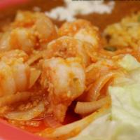 Camarones Al Mojo De Ajo · Shrimp sauteed with red sauce and garlic, served with rice and refried beans and choice of f...