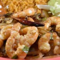 Camaron Ala Plancha  · Shrimp grilled in butter with sliced onions, chopped green onion, and chile arbo