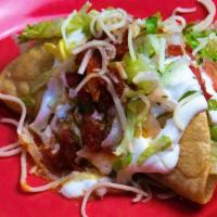 Crispy Taco · Guacamole, sour cream, cheese, salsa, and lettuce.