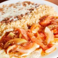 Huevos Rancheros · Two fried eggs served on a lightly fried corn tortilla with tomatoes-chili sauce serve with ...