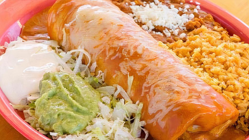 Super Enchilada · 14-inch flour tortilla enchilada with your choice of meat or cheese topped with green or red sauce and melted cheese