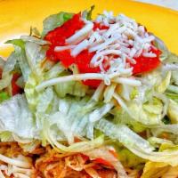 Tostada · Crispy corn tortilla topped with choice of meat, lettuce, refried beans, salsa, sour cream a...
