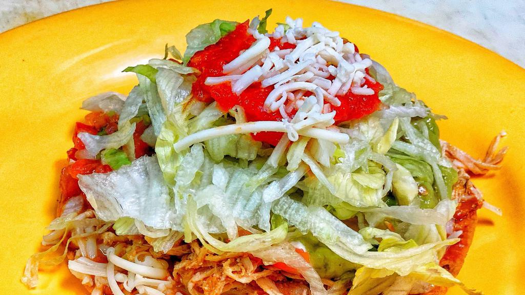 Tostada · Meat, refried beans, cheese, sour cream, guacamole, lettuce, and salsa.