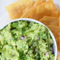 Guacamole Dip · Fresh avocado mixed with lime juice, tomato, onion and cilantro. Served with nacho chips.