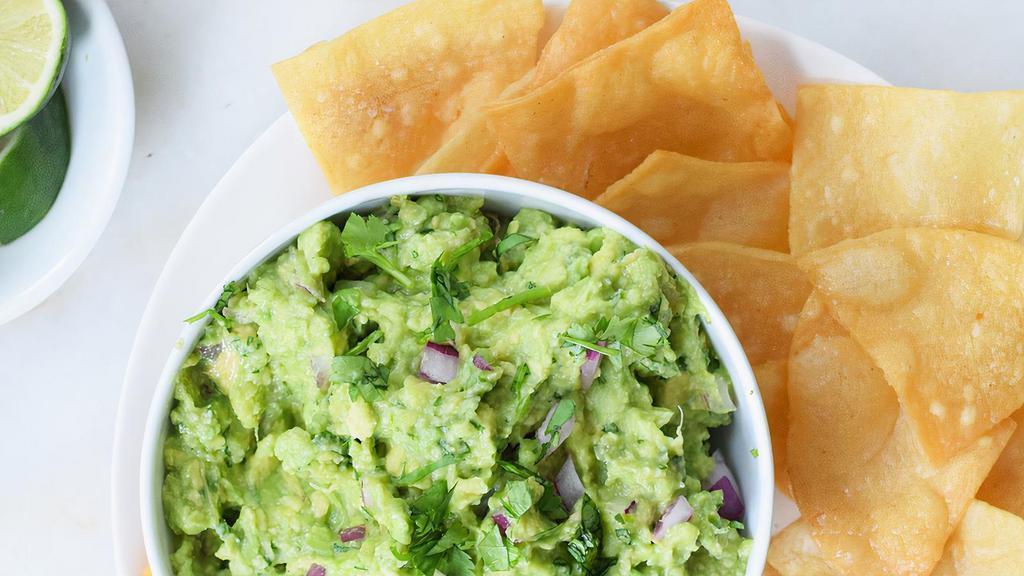 Guacamole Dip · Fresh avocado mixed with lime juice, tomato, onion and cilantro. Served with nacho chips.