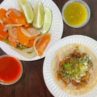 Taco Carnitas · Fried pork, corn tortilla, onions, cilantro, and green salsa.