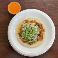 Taco De Birria · Large corn tortilla, birria, onions, cilantro, and a side of spicy salsa.