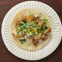 Taco Tripa · Narrow, corn tortilla, onions, cilantro, and green salsa.