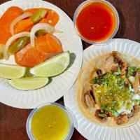 Taco Buche · Pork stomach, corn tortilla, onions, cilantro, and green salsa.