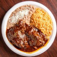 Pollo En Mole Plate · Chicken in mole served with beans, rice, and choice of tortillas.