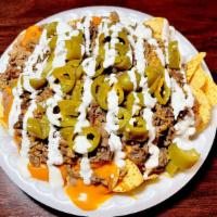 Nachos With Meat · Nachos with your choice of meat. Comes with nacho cheese, jalapeños, sour cream, and beans.