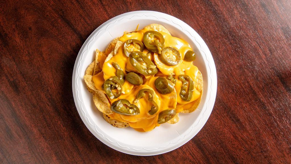 Nachos · Nacho chips with nacho cheese and jalapeños.