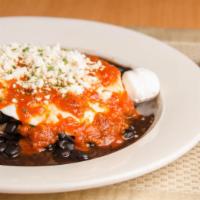 Huevos Rancheros · Two eggs over medium, black beans, feta cheese, sour cream, and ranchero sauce.