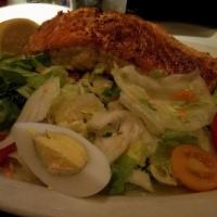 Salmon Salad · Grilled salmon tomatoes cucumber hard boiled egg on a bed of green salad.