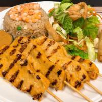 House Chicken Satey · Chicken on skewers Served with shrimp fried rice, green salad, vegetable egg roll, and side ...