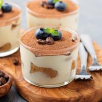Tiramisu Cup · Layers of espresso drenched ladyfingers separated by mascarpone cream and dusted with cocoa ...