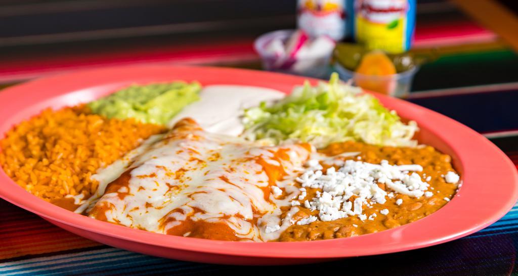 Enchiladas Rojas (Red) · Meat or cheese topped with red enchilada sauce and melted cheese served with rice, beans, sour cream, guacamole, lettuce and a slice of tomatoes.