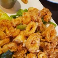 Fried Calamari · Lightly breaded and fried calamari rings and tentacles, served on a bed of lettuce with a ch...