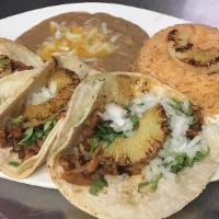Tacos Al Pastor Plate · Marinated pork served with cilantro, onions, grilled pineapple and homemade pastor salsa. Co...