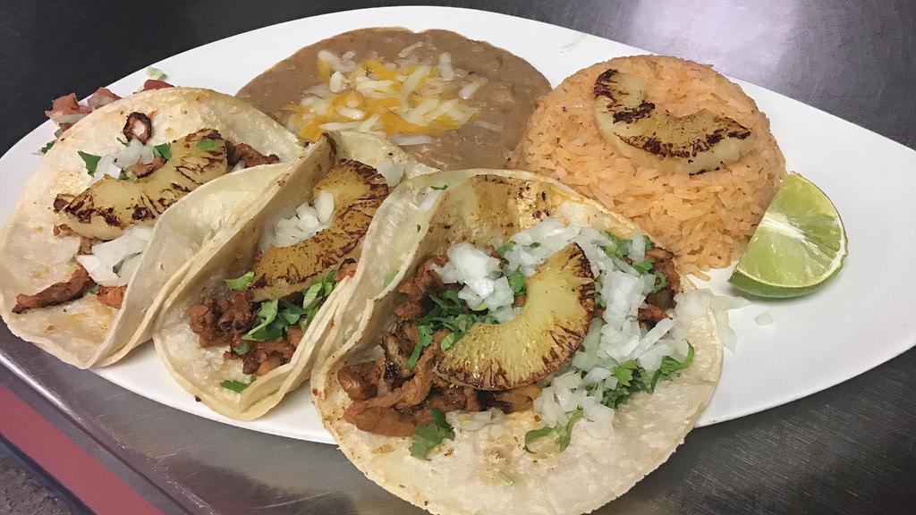 Tacos Al Pastor Plate · Marinated pork served with cilantro, onions, grilled pineapple and homemade pastor salsa. Comes with rice, beans and Guacamole.