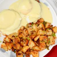 Eggs Benedict · Two poached eggs with ham and hollandaise sauce served on an english muffin. Served with hom...