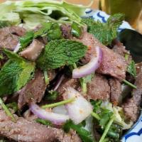 Hot And Spicy Beef Salad · Cooked beef, lettuce, mint, onion, in lemon dressing. Medium spicy.