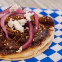 Mole Poblano Taco · Chicken mole top with toasted sesame seeds, queso fresco and pickled onions