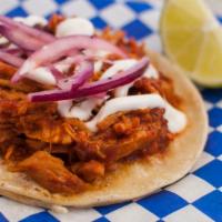 Tinga De Pollo Taco · Chipotle chicken top with pickled onions and sour cream