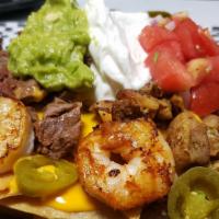 Super Happy Nachos · Grilled Beef, Grilled Chicken and Grilled Cajun Jumbo Shrimp.