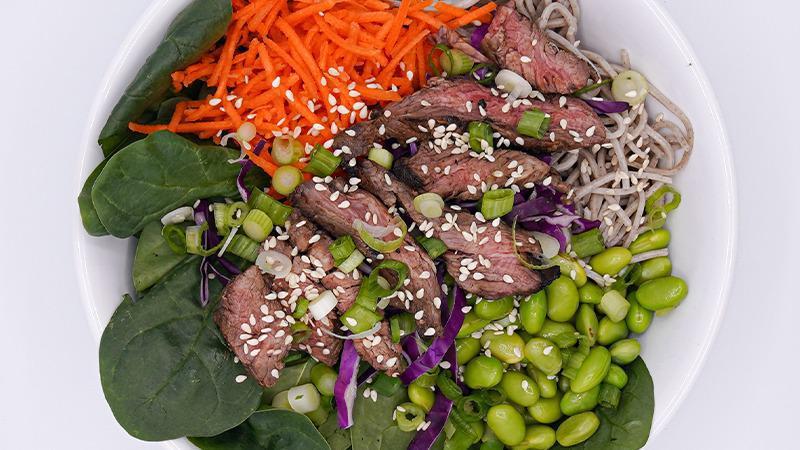 Ichiban Steak · Grass-fed Steak, Soba Noodles, Baby Spinach, Red Cabbage, Shredded Carrot, Edamame, Sesame Seed, Green Onion, Ginger Peanut Dressing