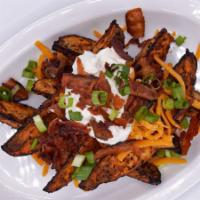 Loaded Potato Wedges · Roasted Potato Wedges topped with Cheddar Cheese, Smoked Bacon Crumbles, Sour Cream, and Gre...