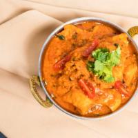 Chicken Curry · Chicken cooked in a light gravy and mild curry. Served with rice, mint and chutneys.