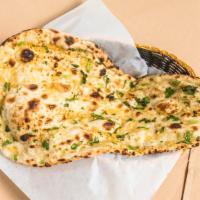 Garlic Naan · Leavened bread baked with fresh garlic and herbs.