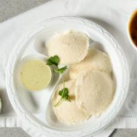 Idly Sambar · Vegan, gluten-free. Rice and lentil steamed cakes dipped in lentil soup or on The side, Serv...